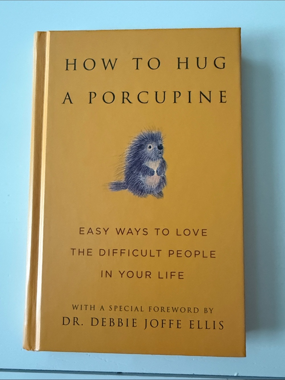How to Hug a Porcupine - Hardcover Book, Mustard Yellow Cover